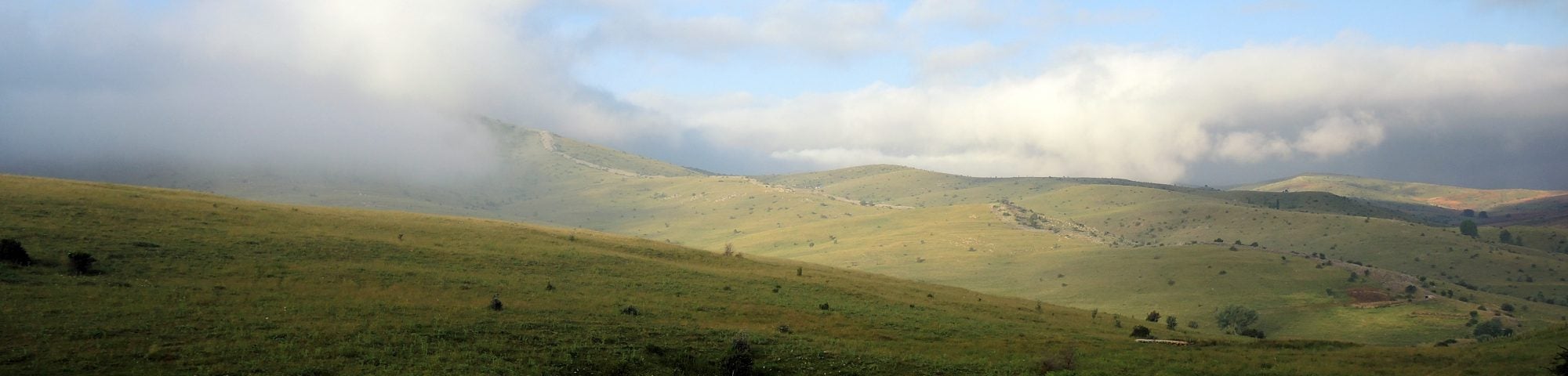 A mountain range with clouds in the sky.