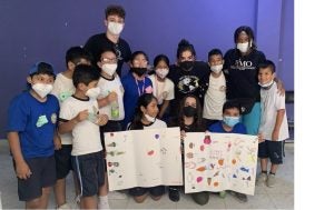 Children standing together holding up posters