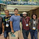 A group of six people stands together at the Ecological Society of America event, smiling in front of a sign. They appear to be attendees or participants.