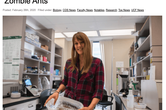 A woman in a lab holding a container, seen in an article titled "Five Year Grant Will Deepen Research Into 'Zombie Ants'". .