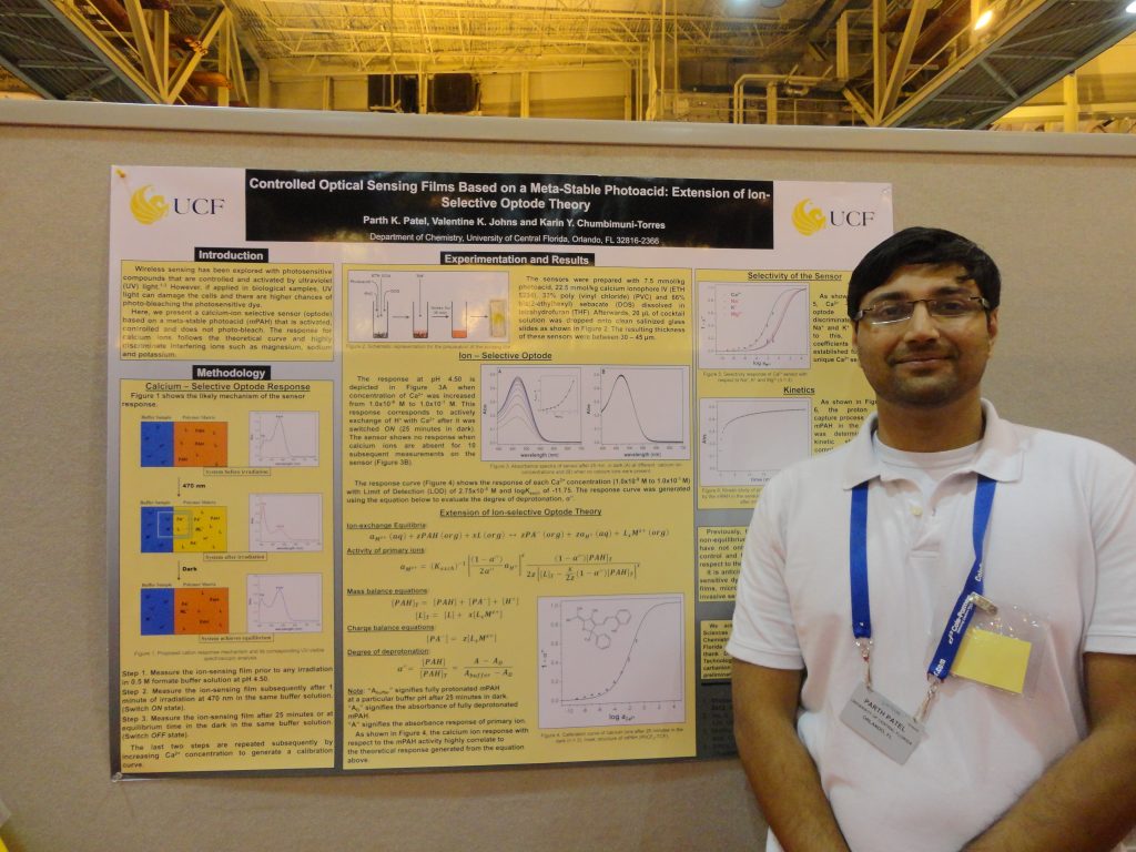 A man presenting a scientific research poster about controlled optical sensing films based on a metal-silole photonic band.