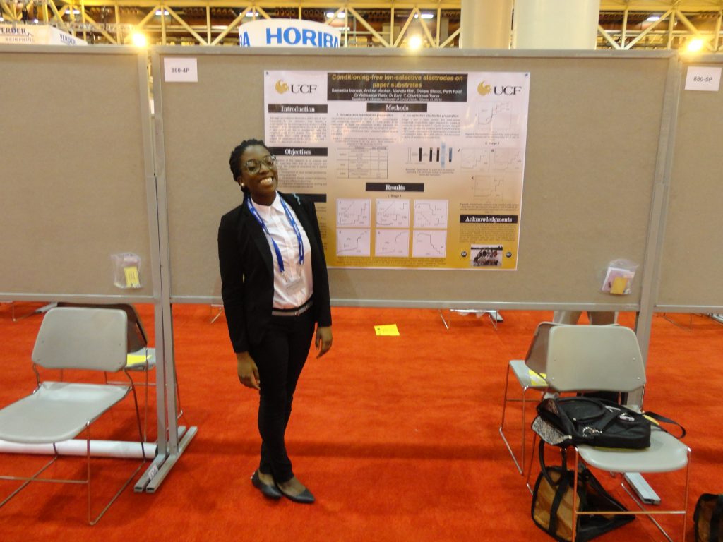 Woman presenting a scientific poster at a conference.