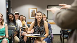 A group of students sitting in a classroom.
