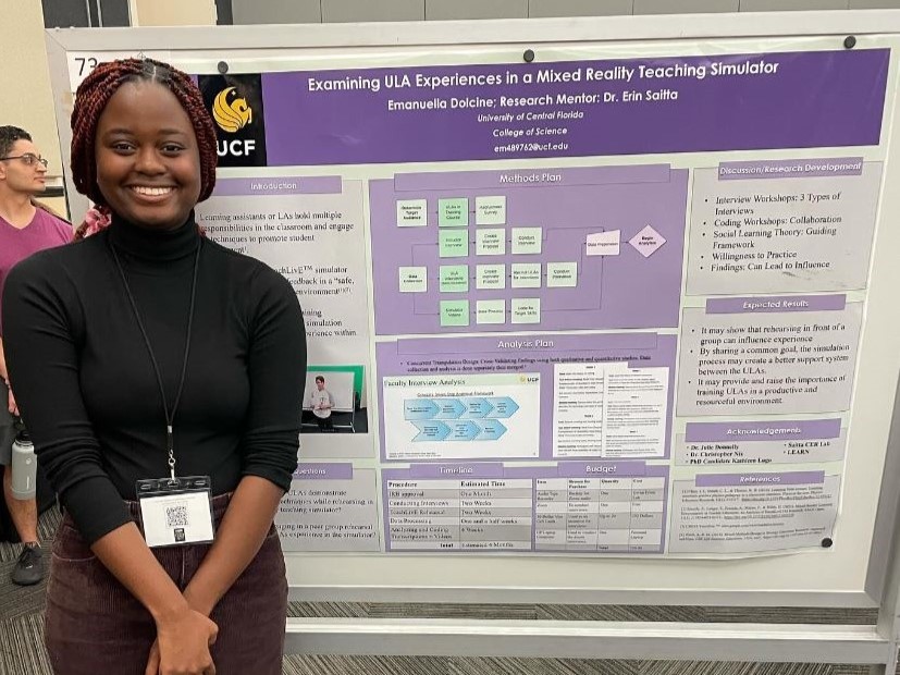 A smiling woman standing in front of a research poster at a conference.