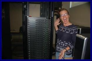 Kay standing in front of a server rack