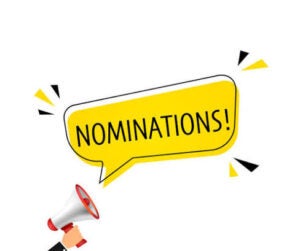 A hand holds a megaphone with a yellow speech bubble above it displaying the word “NOMINATIONS!” on a white background.