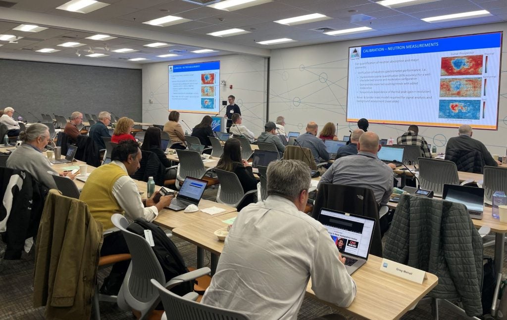 Lunar-VISE team member presenting slides to a conference room of people during the CDR