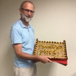 A man holding a cake with 