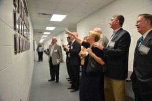 Past Hall of Fame inductees admire the display at the unveiling event.