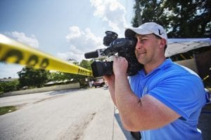 Associated Press video journalist Josh Replogle works the scene near a mass shooting at the Pulse nightclub Tuesday, June 14, 2016, in Orlando, Fla. Replogle helped put himself through college by working at the Pulse dance club for two years. He returned this week to cover the mass shooting at the club. (AP Photo/David Goldman)