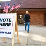 A person walks towards a polling place with a 