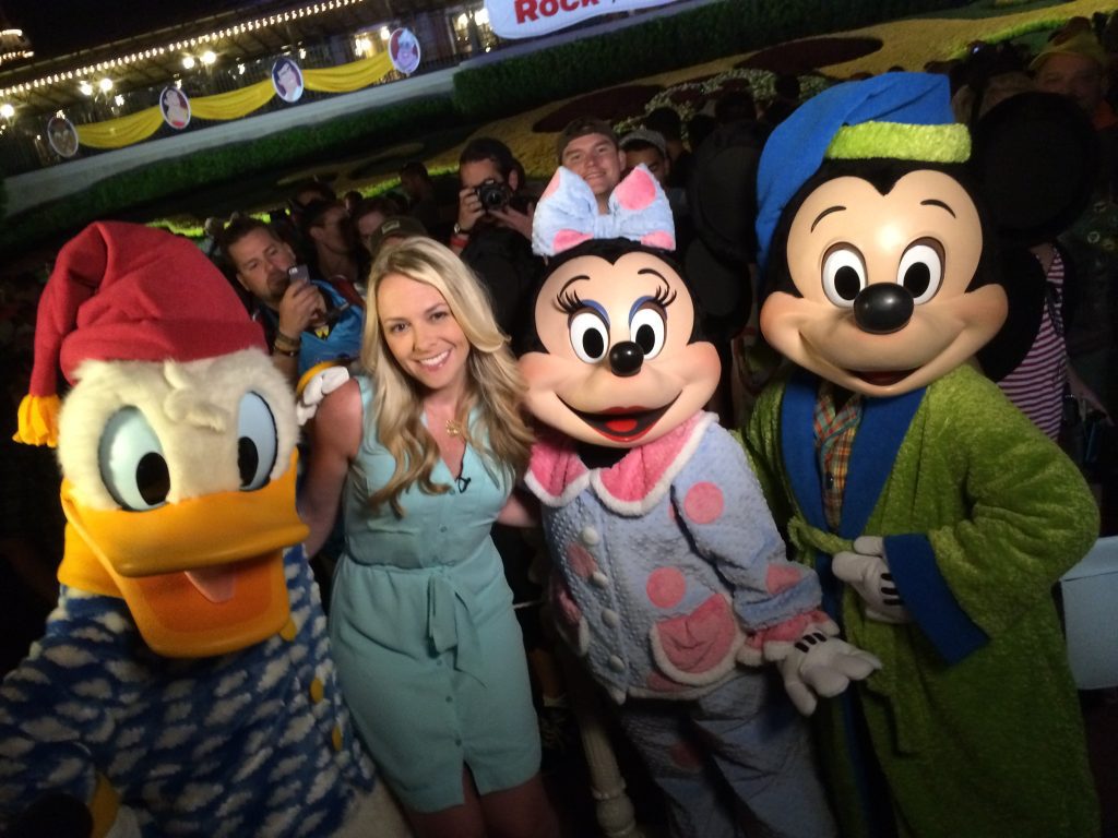 Jennifer Fickley-Baker standing beside Disney characters