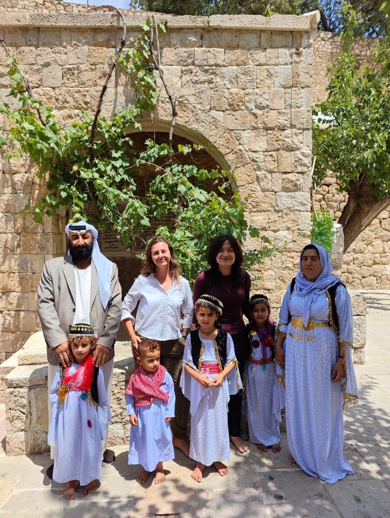 Hannah Barnes and Myli Sangria with a local family in Lalish, Kurdistan.
