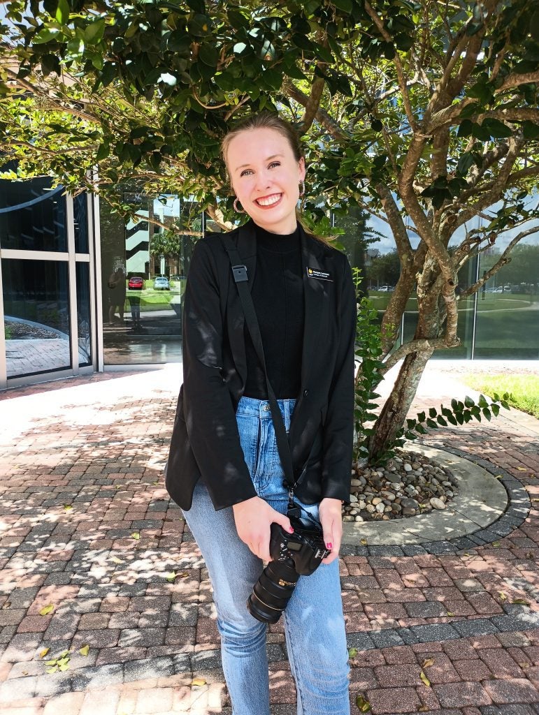 Morgan Lemmen holding a camera at UCF