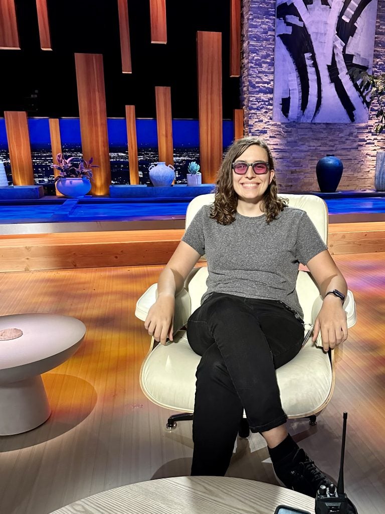 Natalie Gooch sitting on the set of Shark Tank