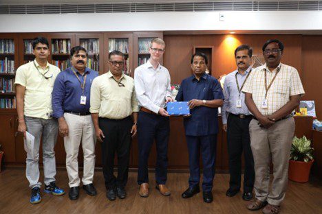 Barry Griffiths, Ph.D. standing beside faculty and administrators of Vellore Institute of Technology 