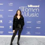 Kendra Hathaway standing on red carpet at 2023 Billboard Women in Music Event