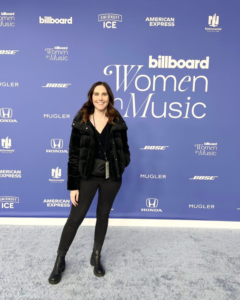 Kendra Hathaway standing on red carpet at 2023 Billboard Women in Music Event