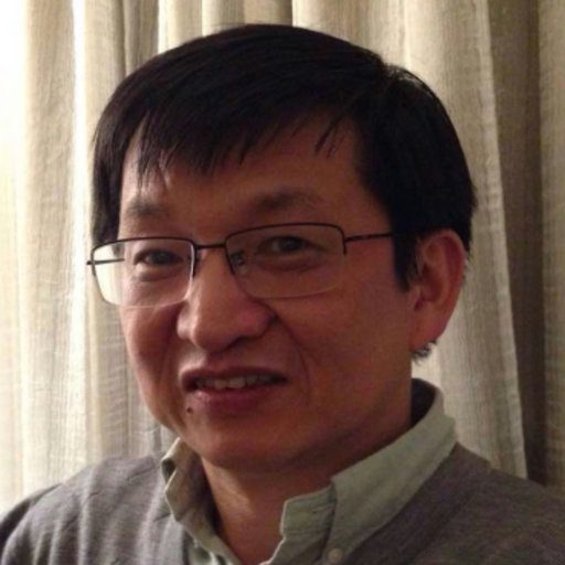 An asian man wearing glasses and a sweater.