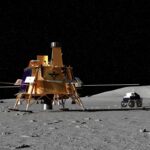 A lunar lander and a rover on a rocky, gray surface of the Moon under a starry black sky.