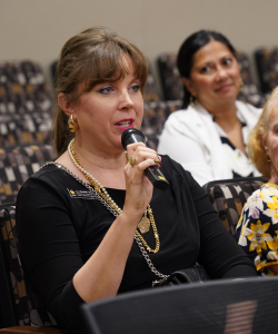 A woman speaking into a microphone.