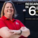 A woman in a red polo shirt stands with arms crossed, smiling. Next to her is text: 