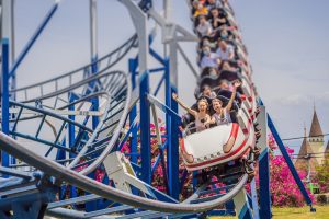 people enjoying themselves on a roller coaster