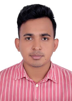 A man with short black hair wearing a pink and white striped shirt poses for a passport-style photo against a white background.