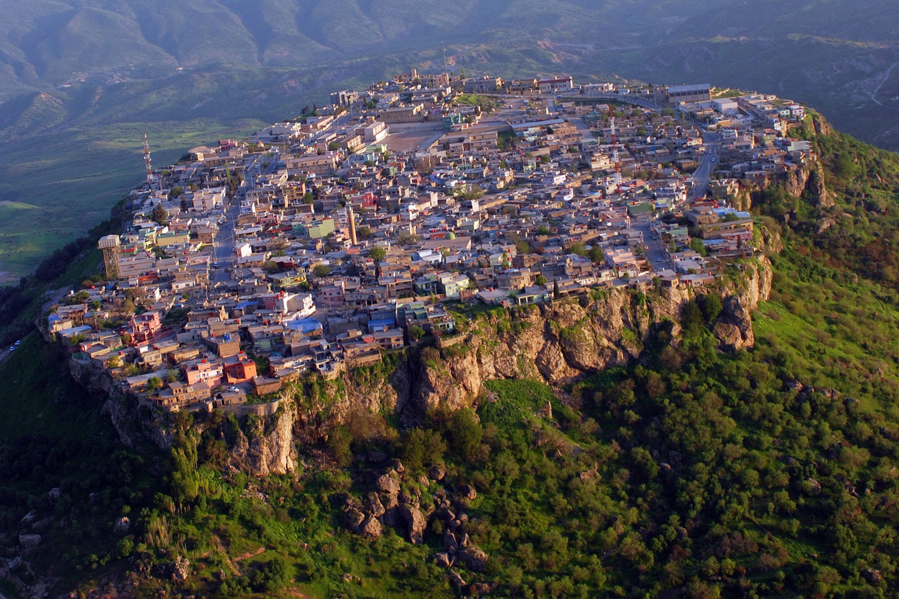 An aerial view of a city on top of a mountain.