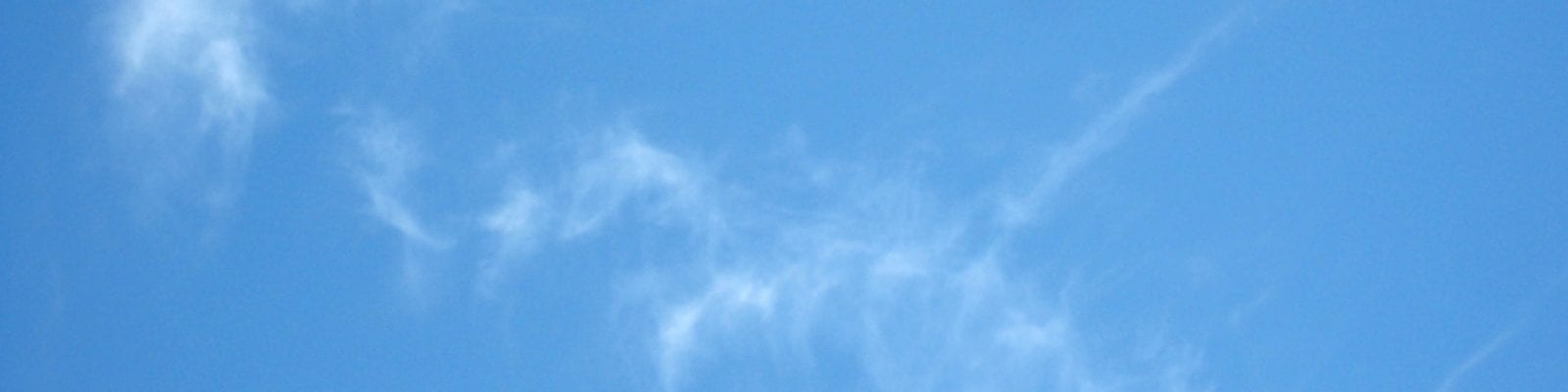 A kite flying in a blue sky.