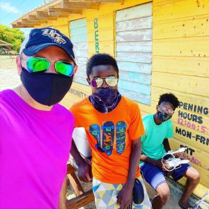 Dr. Hawthorne, UCF associate professor, is pictured here in front of the library in Hopkins Village, Belize with two community scientists after mapping data collection.